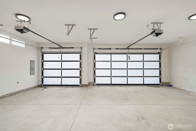 garage with a garage door opener and electric panel