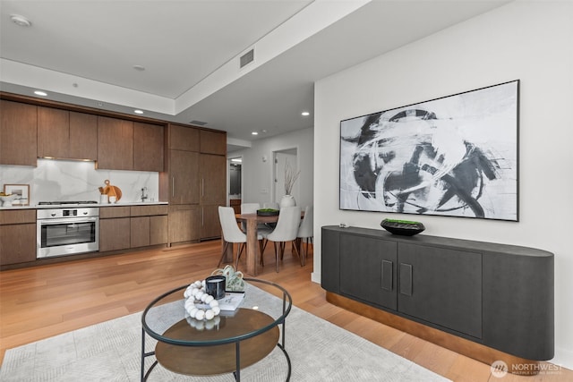 121 Stewart St Unit 2807, Seattle, WA 98101 - living room with light wood-style flooring and recessed lighting