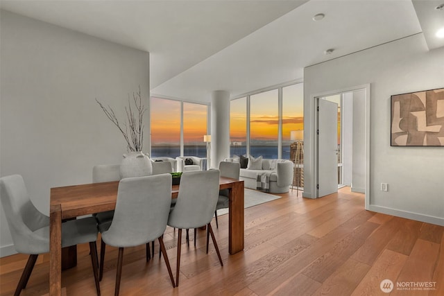 121 Stewart St Unit 2807, Seattle, WA 98101 - dining room featuring wood finished floors and a water view