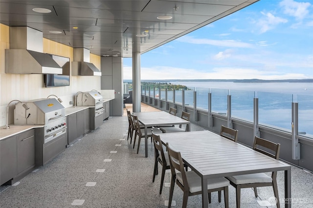 121 Stewart St Unit 2807, Seattle, WA 98101 - balcony featuring a water view, outdoor dining space, and exterior kitchen