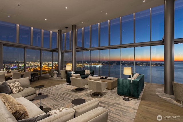 121 Stewart St Unit 2807, Seattle, WA 98101 - living room featuring expansive windows, wood finished floors, and a high ceiling