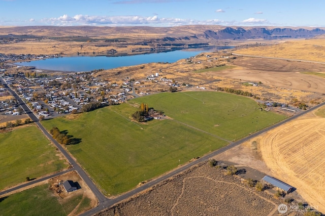 birds eye view of property featuring a water and mountain view