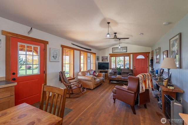 living room with a ceiling fan, wood finished floors, and lofted ceiling