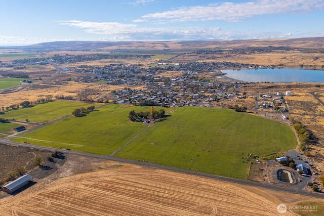 birds eye view of property with a water and mountain view