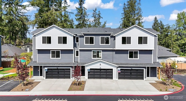 townhome / multi-family property featuring fence, an attached garage, concrete driveway, and roof with shingles