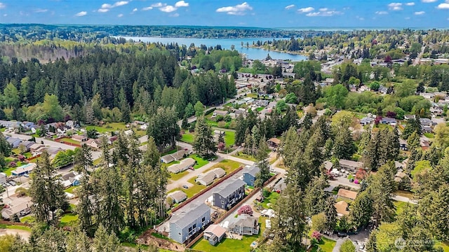 bird's eye view featuring a water view, a view of trees, and a residential view