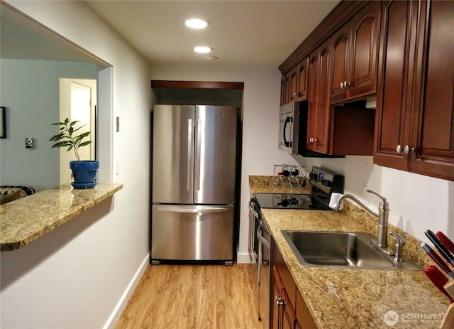 110 NW 39th St, Seattle, WA 98107 - kitchen with appliances with stainless steel finishes, a sink, light wood finished floors, recessed lighting, and baseboards