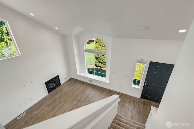 foyer with healthy amount of natural light, wood finished floors, recessed lighting, and baseboards