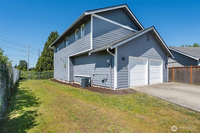 view of side of home featuring central AC unit, a garage, and driveway