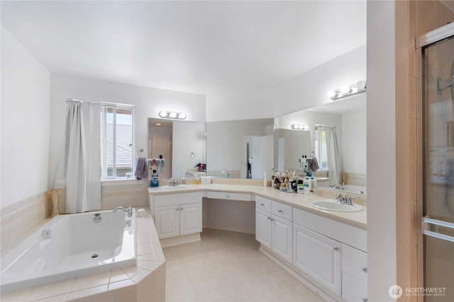 full bath with a garden tub, vanity, and a healthy amount of sunlight