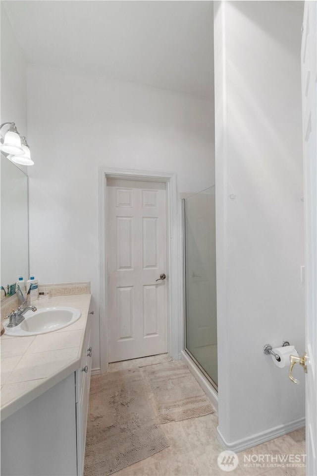 bathroom with a stall shower and vanity
