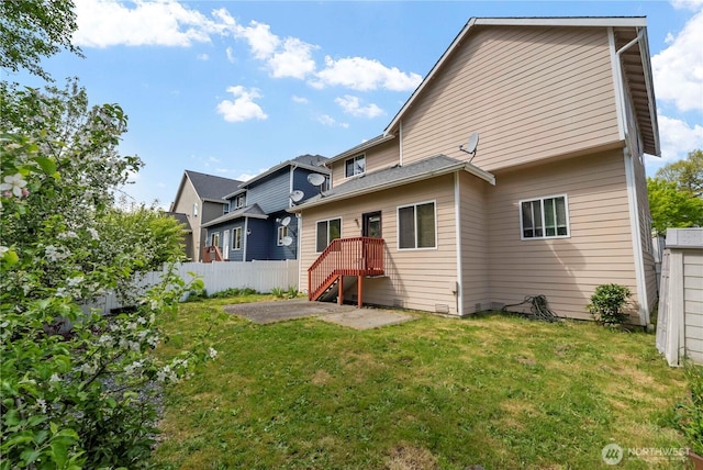 back of house featuring a yard, a patio, and fence