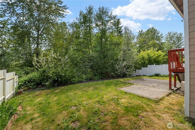 view of yard featuring fence and a patio