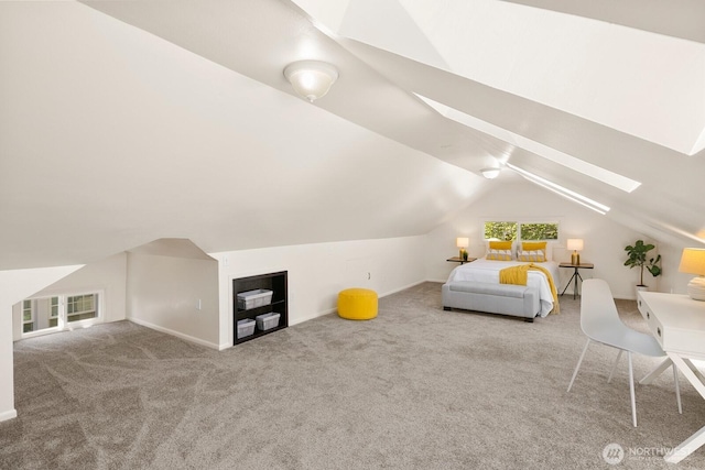 bedroom with vaulted ceiling with skylight, baseboards, and carpet