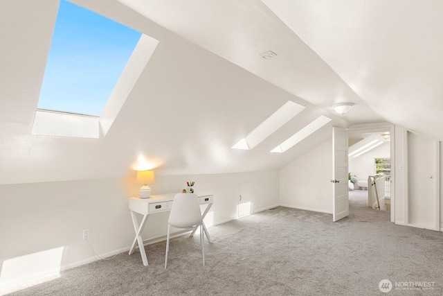 bonus room with carpet flooring, baseboards, and lofted ceiling with skylight