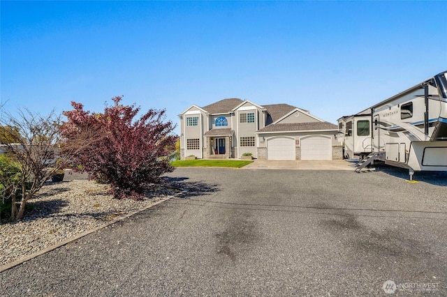 view of front of property featuring an attached garage and concrete driveway