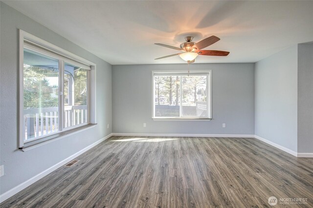 293 Glacier Ct SE, Ocean Shores, WA 98569 - unfurnished room with visible vents, a ceiling fan, baseboards, and dark wood-style floors