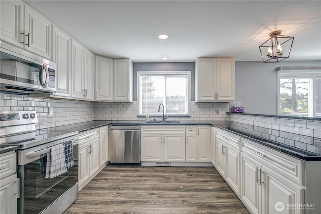 293 Glacier Ct SE, Ocean Shores, WA 98569 - kitchen featuring a sink, appliances with stainless steel finishes, and dark countertops
