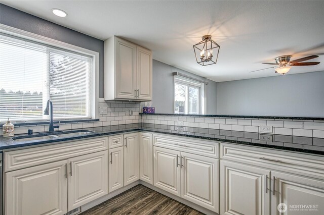 293 Glacier Ct SE, Ocean Shores, WA 98569 - kitchen with a sink, dark wood-style flooring, white cabinets, and tasteful backsplash
