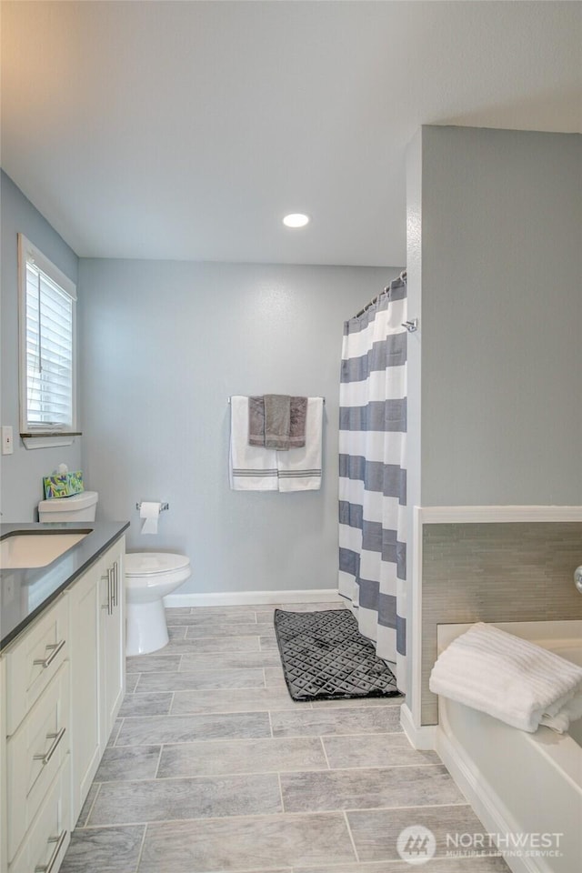 293 Glacier Ct SE, Ocean Shores, WA 98569 - full bathroom featuring vanity, curtained shower, toilet, baseboards, and wood tiled floor
