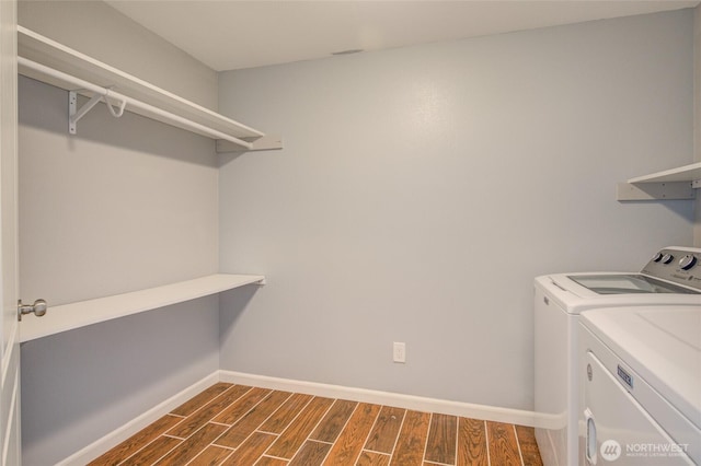 293 Glacier Ct SE, Ocean Shores, WA 98569 - washroom with washing machine and clothes dryer, laundry area, dark wood finished floors, and baseboards