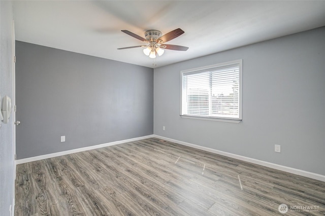 293 Glacier Ct SE, Ocean Shores, WA 98569 - unfurnished room featuring a ceiling fan, baseboards, and wood finished floors