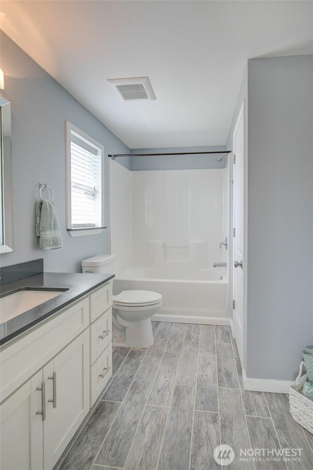 293 Glacier Ct SE, Ocean Shores, WA 98569 - bathroom with wood tiled floor, shower / bathtub combination, vanity, and toilet