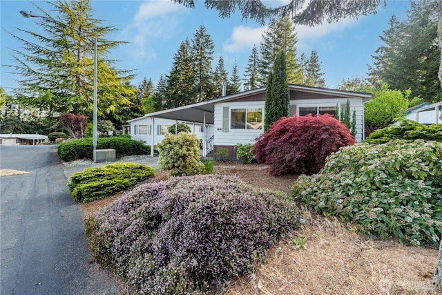 view of property exterior featuring an attached carport