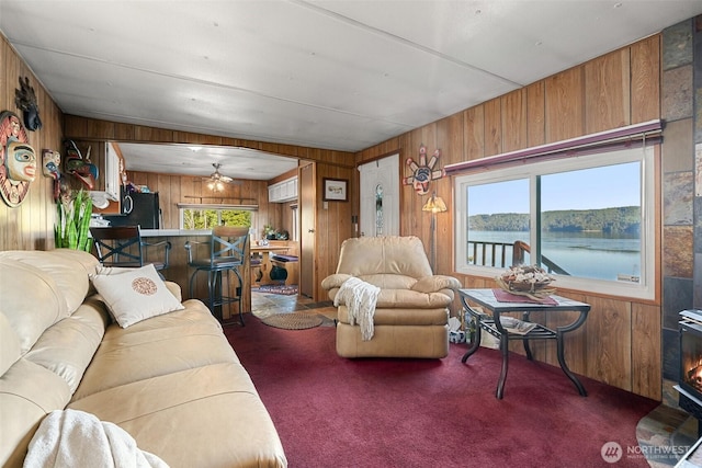 51 N Old Mill Hill Rd, Hoodsport, WA 98548 - living room with wood walls, carpet floors, and a ceiling fan