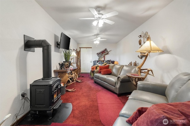 51 N Old Mill Hill Rd, Hoodsport, WA 98548 - carpeted living room with a ceiling fan and a wood stove