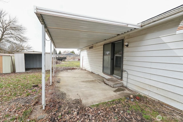 view of patio with a storage unit, an outbuilding, and entry steps