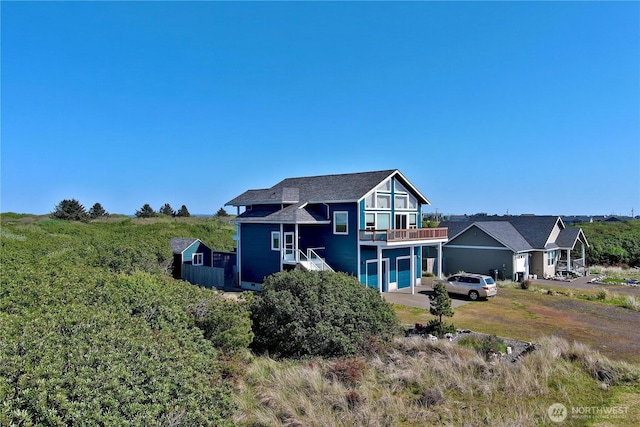 1160 Greenview Ave SW, Ocean Shores, WA 98569 - rear view of property with a balcony and driveway