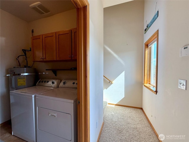 1160 Greenview Ave SW, Ocean Shores, WA 98569 - laundry room with cabinet space, water heater, washing machine and dryer, light carpet, and baseboards