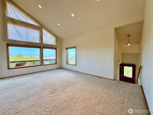 1160 Greenview Ave SW, Ocean Shores, WA 98569 - unfurnished living room featuring high vaulted ceiling, carpet floors, baseboards, and recessed lighting