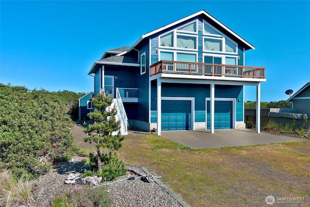 1160 Greenview Ave SW, Ocean Shores, WA 98569 - view of front of home with a garage, a balcony, and driveway