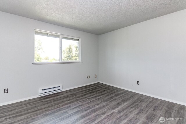 unfurnished room featuring dark wood-type flooring, a baseboard radiator, a textured ceiling, and baseboards