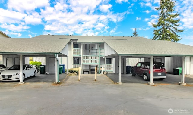 view of vehicle parking with a carport