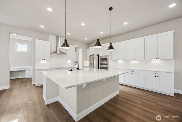 10603 134th Ave NE Unit 102, Lake Stevens, WA 98258 - kitchen with decorative backsplash, a large island, wall chimney range hood, a sink, and appliances with stainless steel finishes