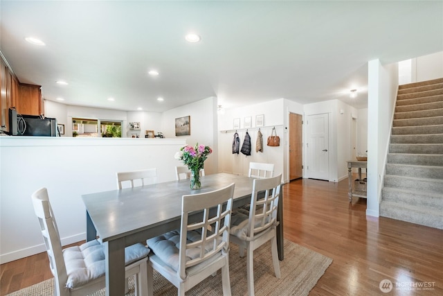 dining area featuring stairway, baseboards, recessed lighting, and wood finished floors