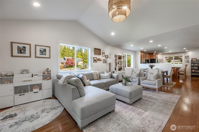 living area featuring vaulted ceiling, recessed lighting, and wood finished floors