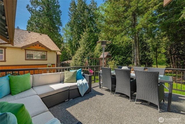 view of patio / terrace featuring a playground, outdoor dining space, and an outdoor living space
