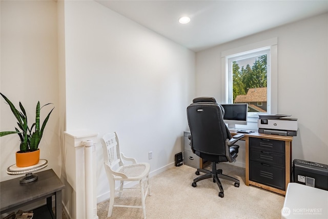 home office featuring baseboards and light carpet