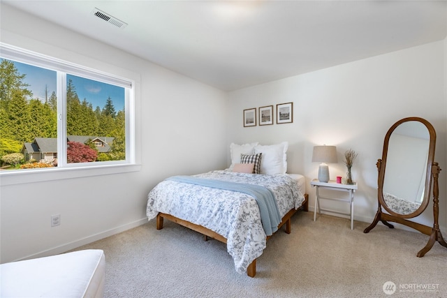 bedroom with light colored carpet, baseboards, and visible vents