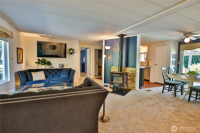 3276 E Harbor Rd, Langley, WA 98260 - carpeted living room with a wood stove and ceiling fan