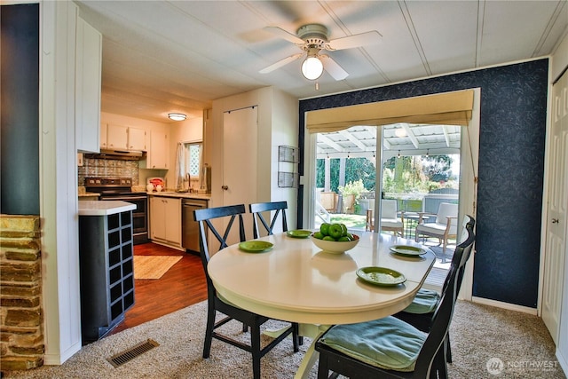 3276 E Harbor Rd, Langley, WA 98260 - dining space with baseboards, a ceiling fan, visible vents, and wood finished floors