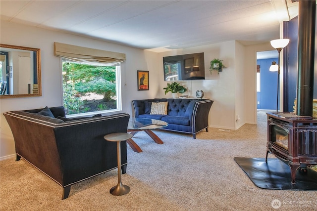 3276 E Harbor Rd, Langley, WA 98260 - carpeted living area with baseboards and a wood stove