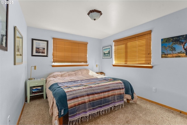 bedroom featuring baseboards and carpet