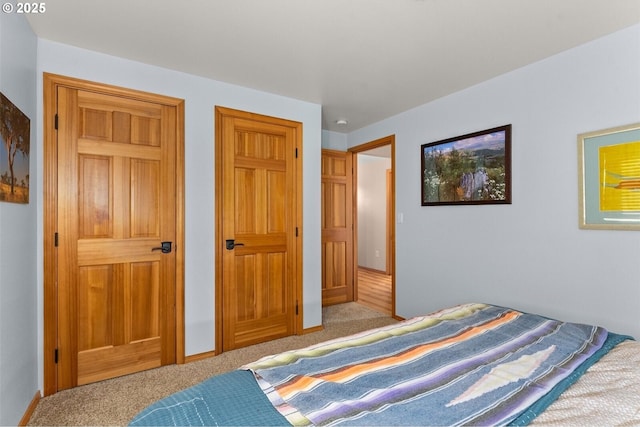 carpeted bedroom featuring baseboards