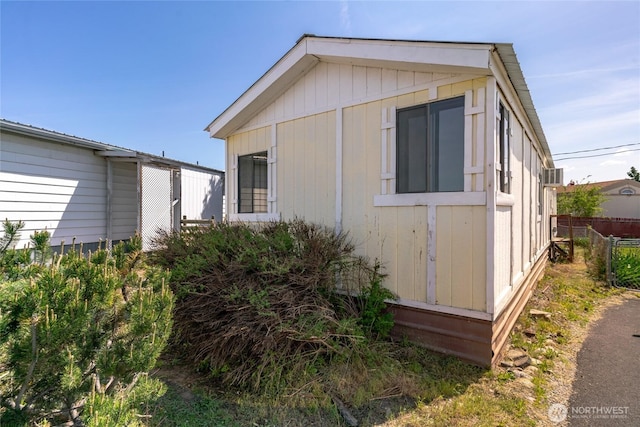 view of side of home with fence