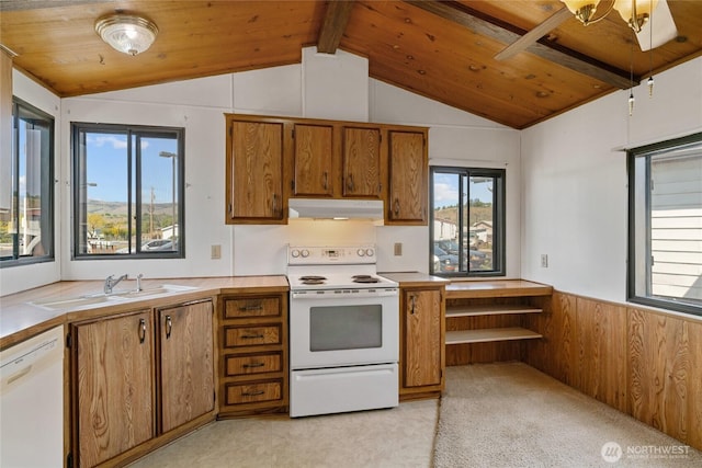 kitchen featuring brown cabinetry, vaulted ceiling with beams, plenty of natural light, and white appliances